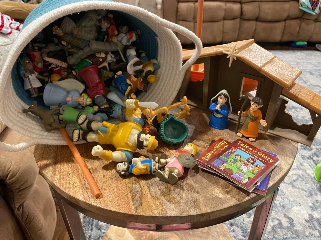 Bible character figures in basket and on table
