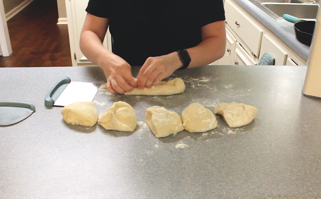 rolling dough and hands pinching together