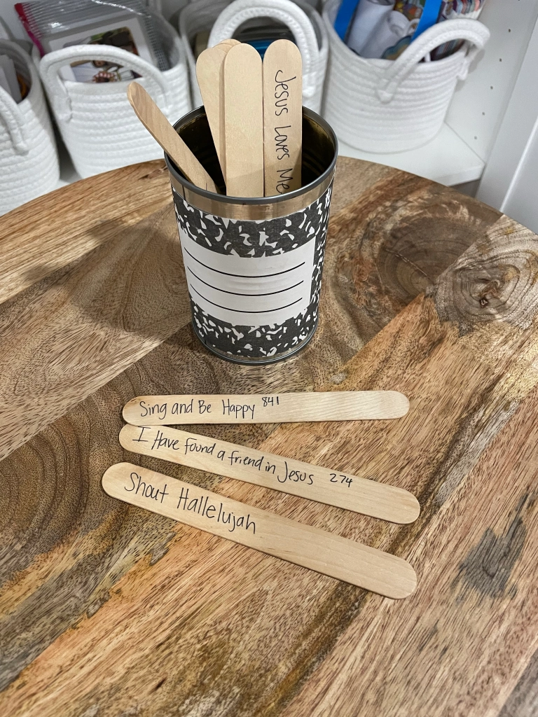 worship songs written on popsicle sticks in a can
