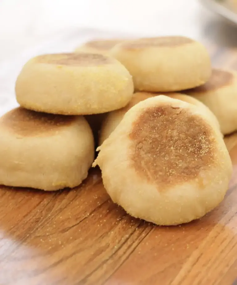 stacked up english muffins on wooden cutting board