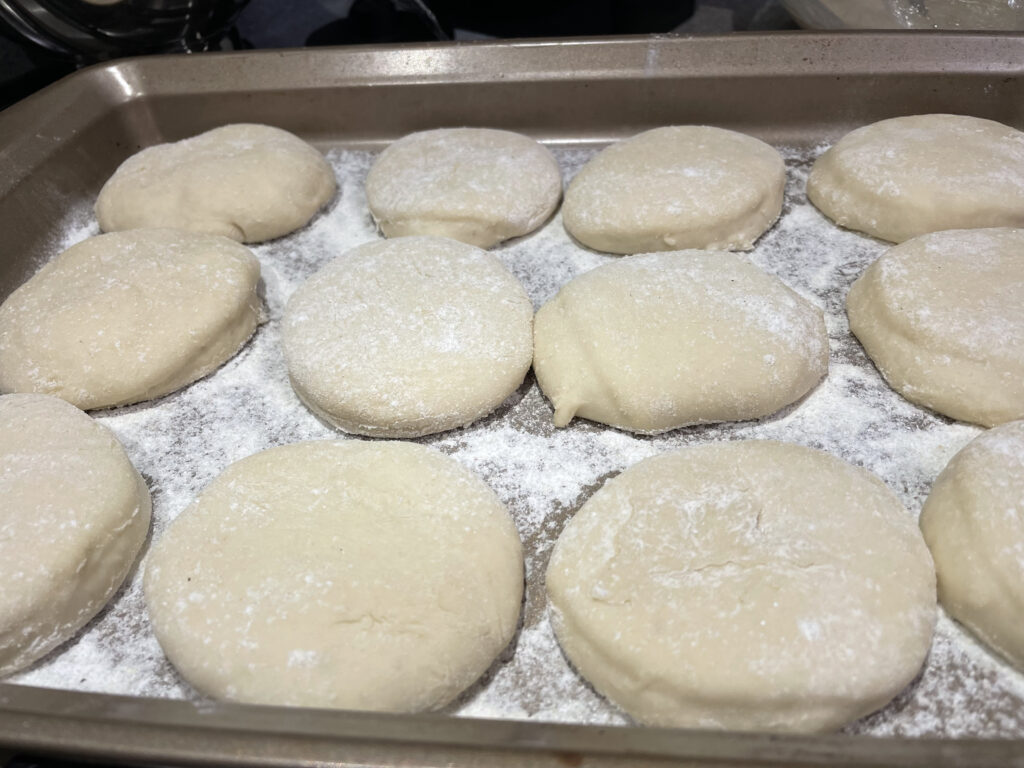 cut out english muffins on cookie sheet