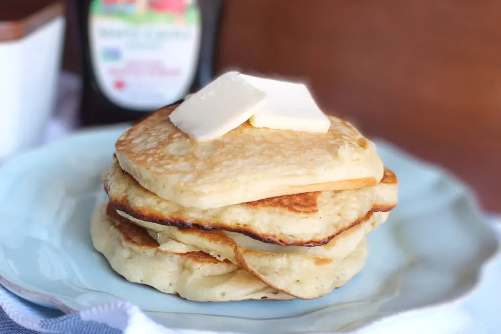 stack of potato flake pancakes with pad of butter on top