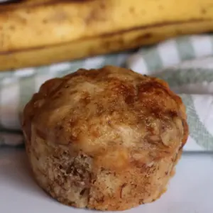 potato flake sourdough banana nut muffin sitting in front of a banana