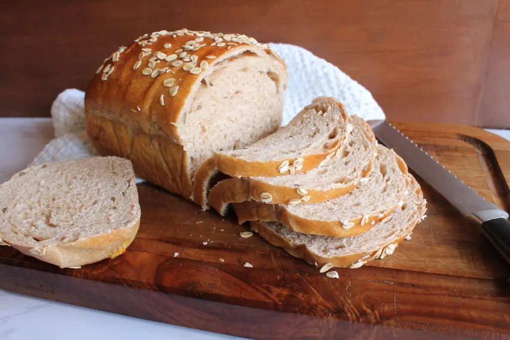 sliced whole wheat loaf bread on cutting board