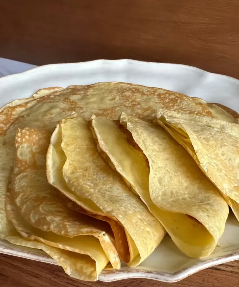 potato flake sourdough crepes stacked and folded on a plate