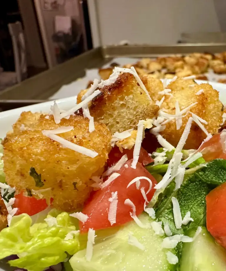 homemade potato flake sourdough croutons on top of a salad