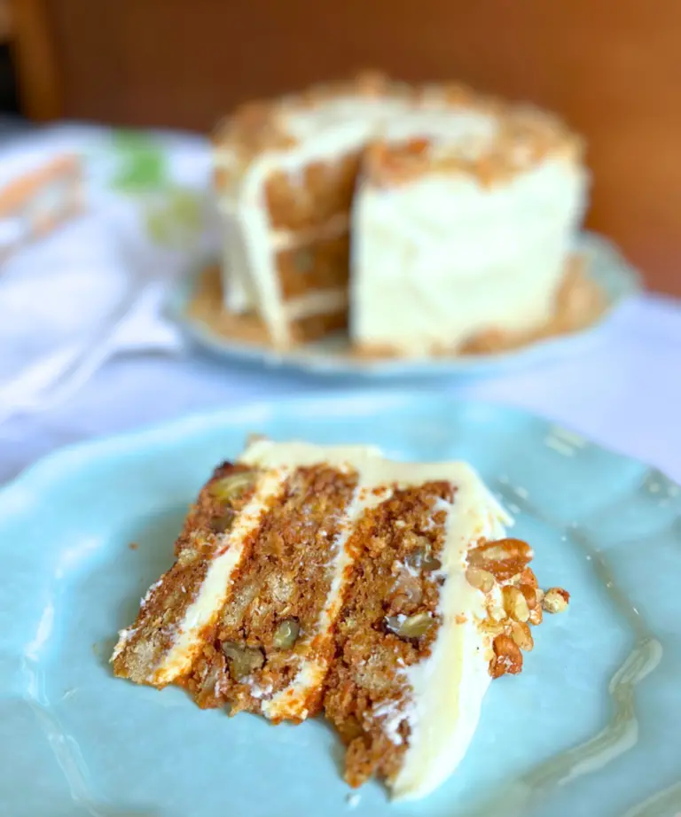 Slice of potato flake sourdough carrot cake on a blue plate